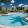 Large swimming pool with plenty of walking and seating space surrounding